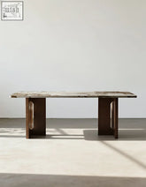 Dudley dining table with a polished marble top and dark brown wooden legs perfect as a sleek round dining table