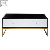 Modern black and white four drawer coffee table with gold-tone metal legs perfect for living room storage