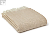Beige dune pure new wool throw with herringbone pattern and cream-colored fringe perfect for cozying up