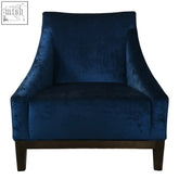 Deep blue velvet ease arm chair with sleek modern design and dark wood legs for stylish comfort