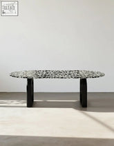 Black dining table eaton dining table with black terrazzo speckled oval top and sleek modern legs