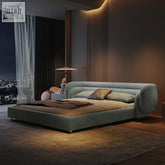 Modern sage green eclipse bed with plush upholstery and sleek rounded frame in a low-profile design