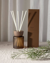 Brown ceramic eden clay reed diffuser with white reeds and matching glass base by chiffield for home fragrance