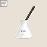 White ceramic diffuser holder with black reed sticks and eym branding from eden diffuser collection
