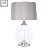 Edna small table lamp with clear glass globe base and silver silk shade for a sleek modern look