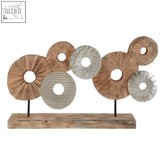 Element 7 disc wooden sculpture featuring wooden and metallic circular discs on a rustic wooden base