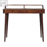 Dark brown chestnut chest of drawers made of mango wood with two drawers and brass knobs on a wooden desk