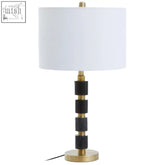 Elin black marble and brushed gold table lamp with white cylindrical shade and patterned black and gold base