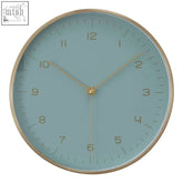 Elko wall clock with mint green face, gold-toned hands and numerals, and a thin metallic frame for visual appeal
