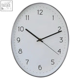 Silver-framed oval wall clock with white face black numerals and hands featuring a dark grey finish wall clock design