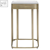 Ella gold side table with gold-toned metal frame and white rectangular glass top with ridged edge detailing