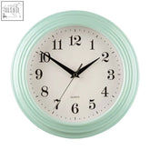 Pale blue quartz wall clock with mint green frame and black curling numbers perfect for vintage decor