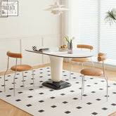 Modern elmer dining table with white oval top black sleek base and tan leather chairs for stylish dining room setup