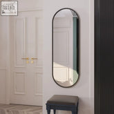 Emi 120x40cm black metal runway oval mirror with matte black minimalist frame mounted on white wall