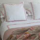 White pillowcases with delicate pink and red striped trim from the empress pink duvet cover set