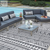 Black and white geometric pattern on enyhom large grey outdoor rug made of durable plastic straw for outdoor patio use