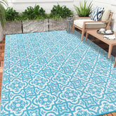 Turquoise and white patterned reversible outdoor rug made of plastic straw for garden patio and camping use