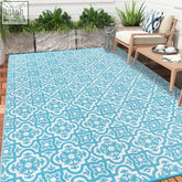 Turquoise and white patterned reversible outdoor rug made of plastic straw for garden patio and camping use