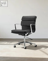 Black leather ergo office chair lowback with chrome metal frame and five-star base for office use