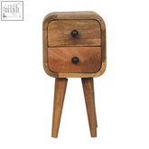 A rustic extra mini curved oak-ish bedside table with two drawers black knobs and mango wood tapered legs
