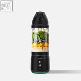 Black fridja f500 portable blender filled with fresh greens blueberries and mango chunks for on the go use