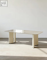 Felicia marble dining table with a sleek polished marble top and cream-colored cylindrical legs modern minimalist dining table
