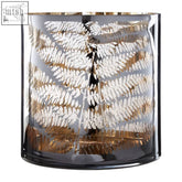 Fern large glass hurricane candle holder with a dark reflective base and gold-leaf fern patterns on glass surface