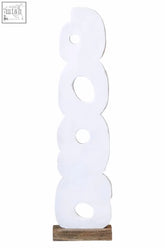 White abstract wood ring sculpture with circular cutouts on a rustic wood base in distressed white finish