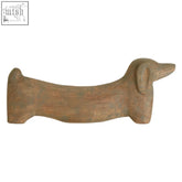 Terracotta ceramic sausage dog doorstop with smooth texture in mango wood style for home decor use