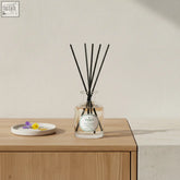 Clear glass reed diffuser with black reeds and parks label offering continuous fine fragrance of camomile violet and honey