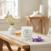 White glass fine fragrance candle with sweet chamomile violet and golden honey scent made in england