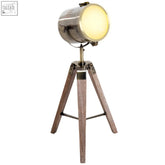Industrial-style floor lamp with brushed metal spotlight head and wooden tripod base in bronze colour