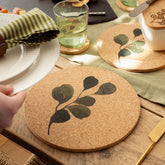 Circular cork place mat with dark green leafy branch design heat resistant and eco friendly place mat