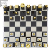Black and white checkered flos marble and wood chess set with gold topped wood chess pieces for stylish play