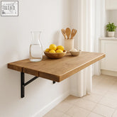 Rustic solid wood table with natural finish and heavy duty black metal brackets wall mounted and foldable