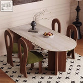 Modern frederica dining table with light gray sintered stone top and dark wood legs paired with green upholstered chairs