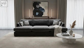 Dark gray fabric freedom sofa double chaise with geometric throw pillows and matching stool with light blanket draped