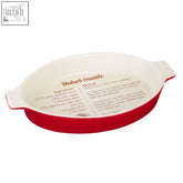 Red ceramic from scratch oval baking dish with white interior and printed rhubarb crumble recipe for easy oval baking