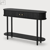 Black oval console table with vertical slat detailing gold knobs and sliding tambour doors for stylish storage