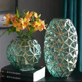 Two teal glass galato vases with gold geometric lattice patterns in round and oval shapes perfect for decor