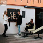 Black wooden-framed scrabble board with letter tiles on the grid for giant words wall game fun with the player