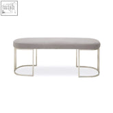 Modern gilden grey bench with a sleek upholstered grey seat and minimalist chrome metal legs with curved base