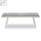 Gilden grey velvet bench with tufted cushions and brushed silver frame featuring slender white legs