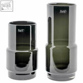Two sleek dark green mouth blown glass vases with modern geometric design and dutz logo smoke finish