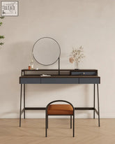 Modern navy blue glazier dressing table with black metal frame and round mirror paired with orange stool