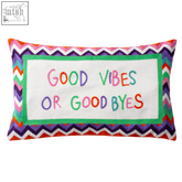 A rectangular good byes needlepoint pillow with colorful zigzag border and good vibes stitched on white panel