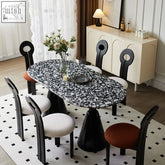 Gordon dining table black and marble with a glossy black and white speckled oval top perfect for dining spaces