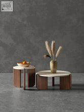 Modern minimalist goto coffee table with curved wooden legs and light marble top made from natural materials