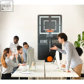 Black wall-mounted basketball hoop with orange net and home guest text holding an orange ball grand basketball