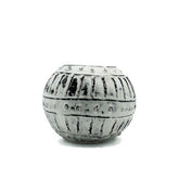 A round matte gray bubble clay plant pot with black vertical ridges perfect for greek bubble clay decor
